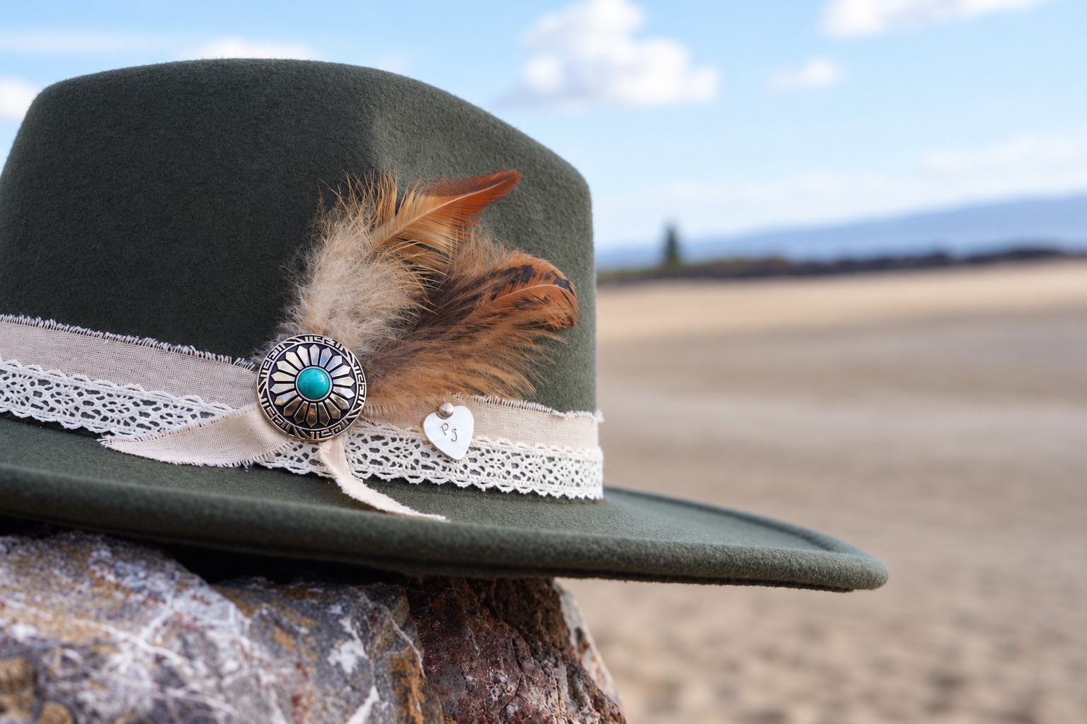 Prairie Jane olive green hat with feathers, lace and turquoise concho by the coast